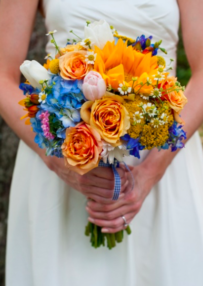 Bride holding a bouquet of summer flowers